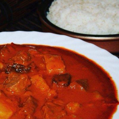 Mahfe - beef stewed in peanut butter tomato sauce, served with carrots, sweet potatoes, and your choice of more veggies and white rice