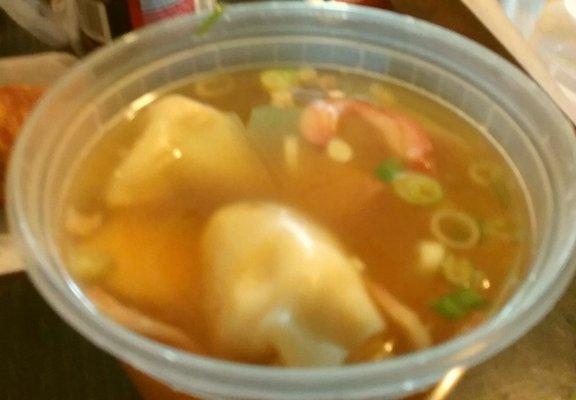 Wonton soup with chunks of meat in broth