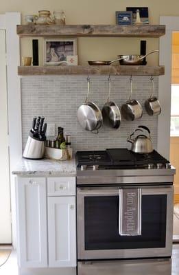 Rustic Shelves, Hanging Pots, Carrerra Marble tile in a great White Kitchen