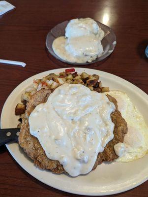 Chicken fried steak breakfast with country potatoes and biscuits and gravy!