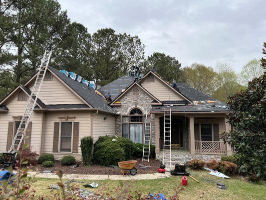 The Tough As Nails Roofing team working on a full roof replacement