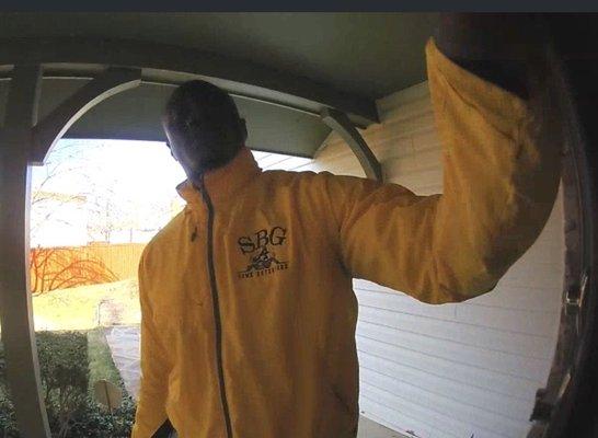 Door-to-door SBG salesman ignoring "no soliciting" sign.