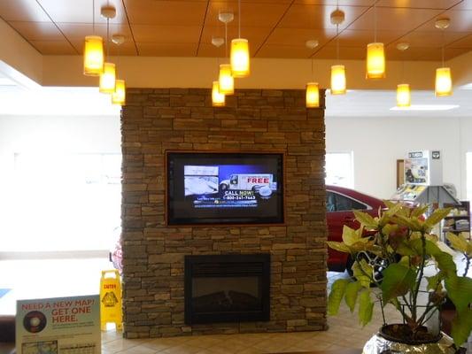 Customer Lounge with Fireplace and TV.