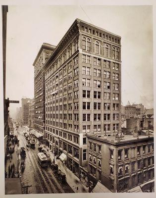 The Mercantile building 1910 with Straus Tobacconist on the left of the white awning in the center of the building.