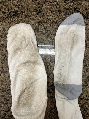 Socks (one is a compression sock) showing how dirty the floor was.