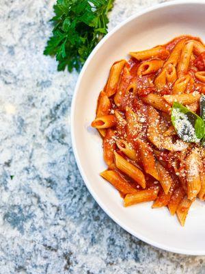 Organic pasta in organic Brooklyn made Sicilian sauce with parmigiana and basil.