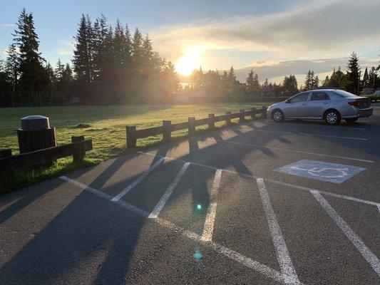 The parking lot overlooks the field.