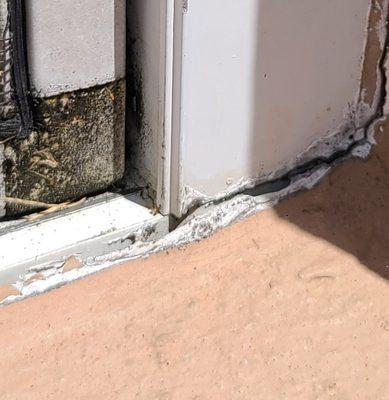 This picture is of a window base where the sealant wore out over time from heat and weather and now is creating an area for water intrusion