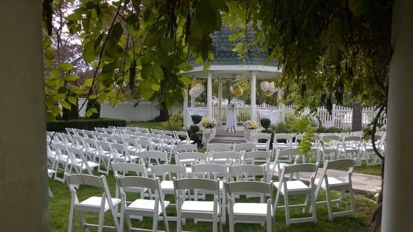 The garden area set up for a wedding around the gazebo.