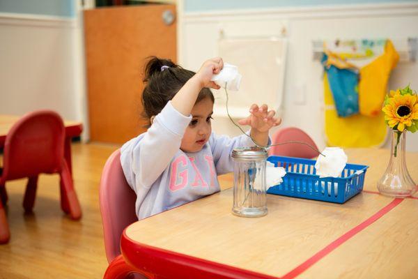 Toddler Student Does A Practical Life Activity