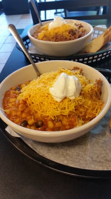 Half drunkin chicken and half bumble bee stew over white rice with cheese and sour cream on top.