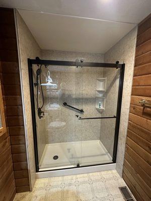 As you can see, we installed a beautiful walk-in shower with all black fixtures with the exception of the corner three tier corner shelf.