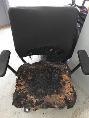 Chair that was in fire in building left in hallway