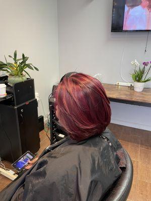 Volume layered cut with red highlights over burgundy base and brazilian hair straightening