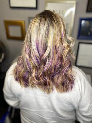 Blonde Balayage highlights with purple pieces.