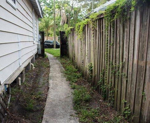 Before Picture Concrete Walkway and Wooden Fencing