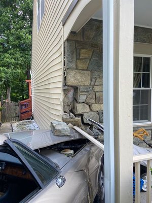 Car crashed into the corner of the house