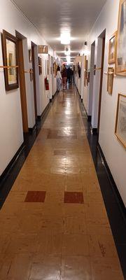 Hallway featuring paintings and artwork as you explore today's rummage sale.