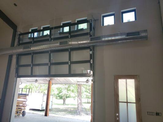 Glass garage door, customer decided to put one in their living room. Has 10 foot vertical lift with manual operation.