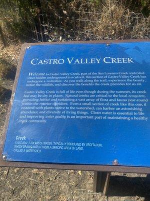 Sign explaining creek environment, trials.