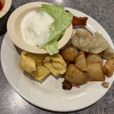 Salad, pot stickers, chicken wing, potatoes, crab rangoon