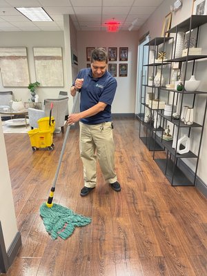 Mopping floor at client facility