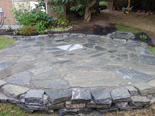 Flagstone patio with stone walls and steps.