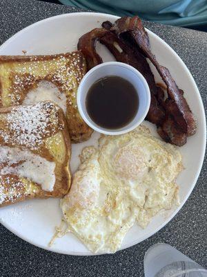 French Toast, 2 over easy eggs, and bacon.