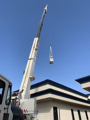 Crane lift to install rooftop package units.