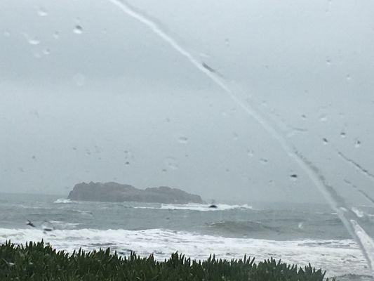 Rainy day view of the beach from the car