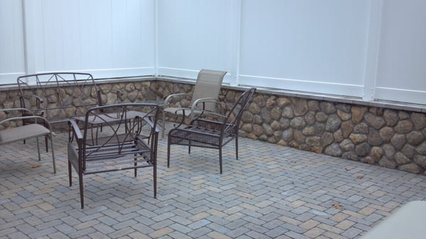 Veneer wall with eco friendly pavers. PVC fencing from Certainteed. Installed by us in Charlestown Ma