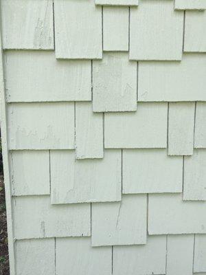 Damage to cedar shake shingles caused by Midwest Painting & Services