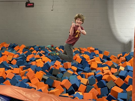 My son jumping into the foam pit.