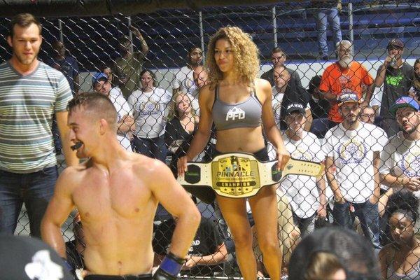 Matt winning the Championship and becoming the number 1 ranked flyweight in the state. His opponent's fans are salty in the background.