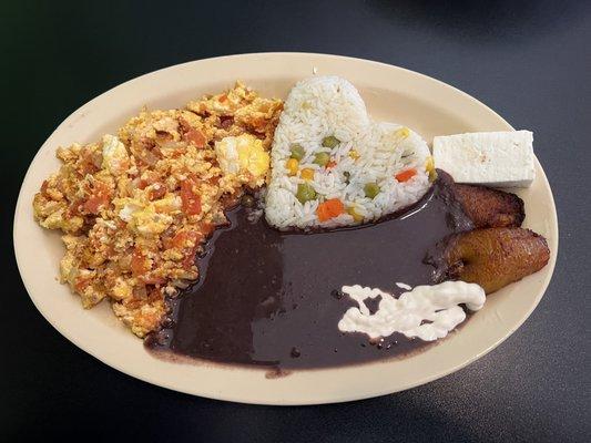 Scrambled eggs, rice, black beans, plantains and cheese.