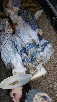 Dolls being stored in hatch behind couch. Everything ruined and moldy. (Outside trim pulled away letting water in)