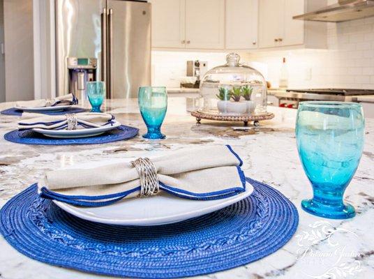 Blue place setting, home staging, marble countertop