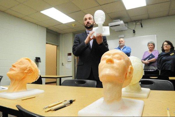 Prof. Dan Shea demonstrates the armature students use for building wax heads during restorative art