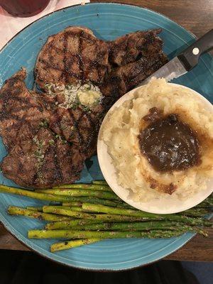 Ribeye steak, mashed potatoes with gravy and asparagus