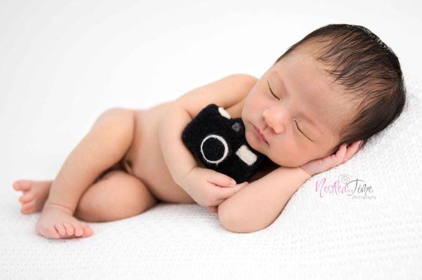 All in studio newborn sessions include props, outfits, natural bean bag poses, and one prop set up (based on availability).