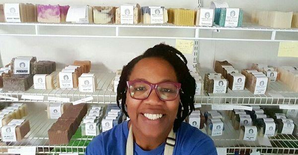 Jackie, the soap artisan, poses in front of her soapy works of art.