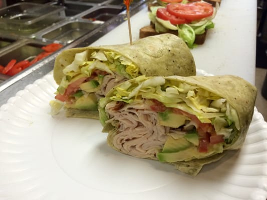 #2 - Avocado Fantasy Sliced turkey breast, avocado, lettuce, tomato, and honey mustard in a spinach wrap.