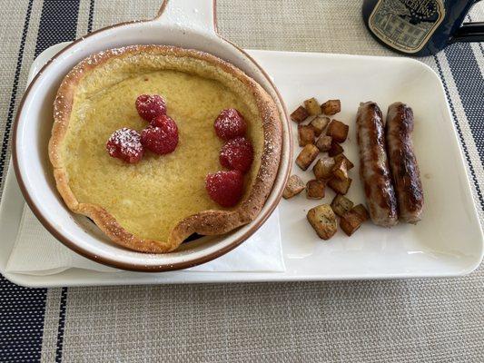 Dutch baby with raspberries, potatoes, and sausage