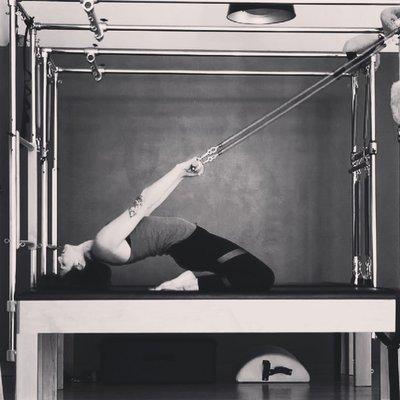 Trainer Allie Justice displays flexibility on a Pilates Cadillac