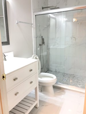 Tile work, plumbing, electric and installation toilet and cabinet with valve.