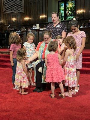 Our children praying over our intern as she goes to her next ministry.