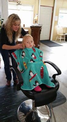 I' m giving this little girl her first hair cut.