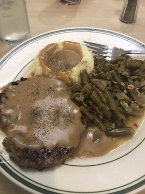 Hamburger steak and gravy, green beans, mashed potatoes.