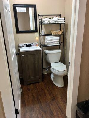 Room 6 ~inside bathroom, offer updated toilet, sink, flooring, has a shower stall