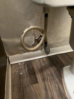 Hole behind toilet